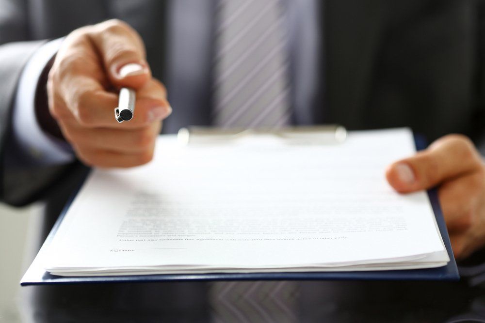 Insurance Agent Holding A Pen And Clipboard