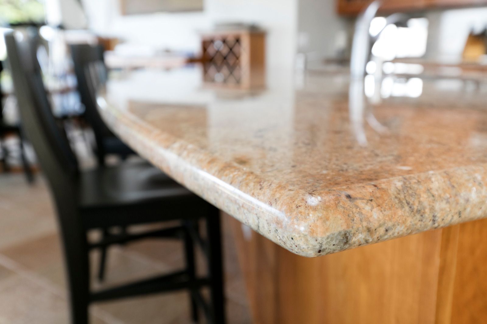 White marble-look kitchen island with bold black veining in a modern kitchen.