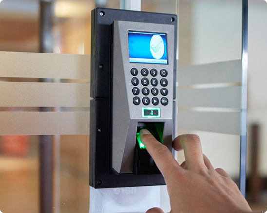 A person is pressing a button on a fingerprint scanner.