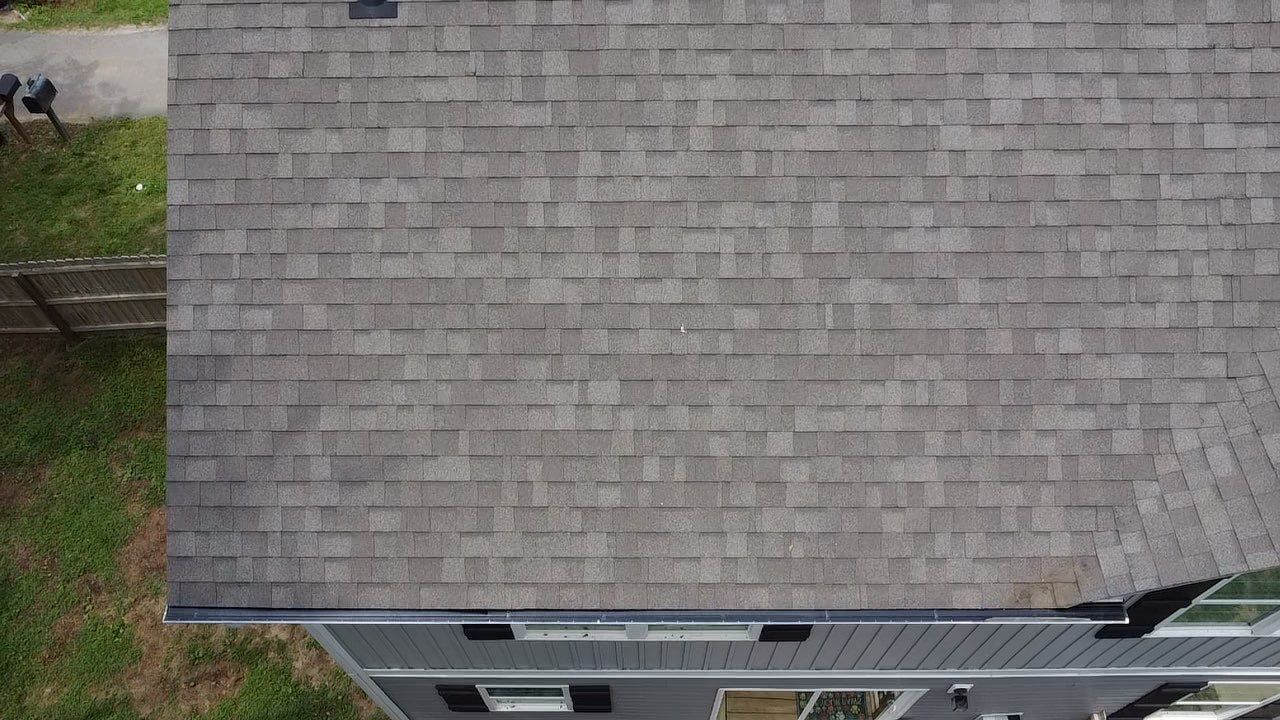 An aerial view of a house with a gray roof.