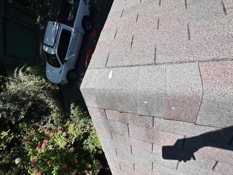 A white truck is parked on the roof of a building.