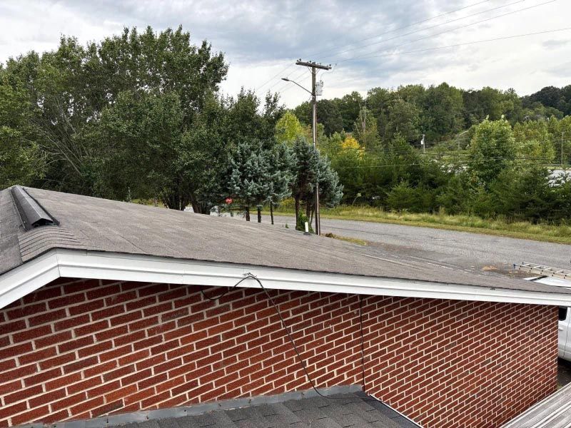 A brick building with a roof that is covered in shingles.
