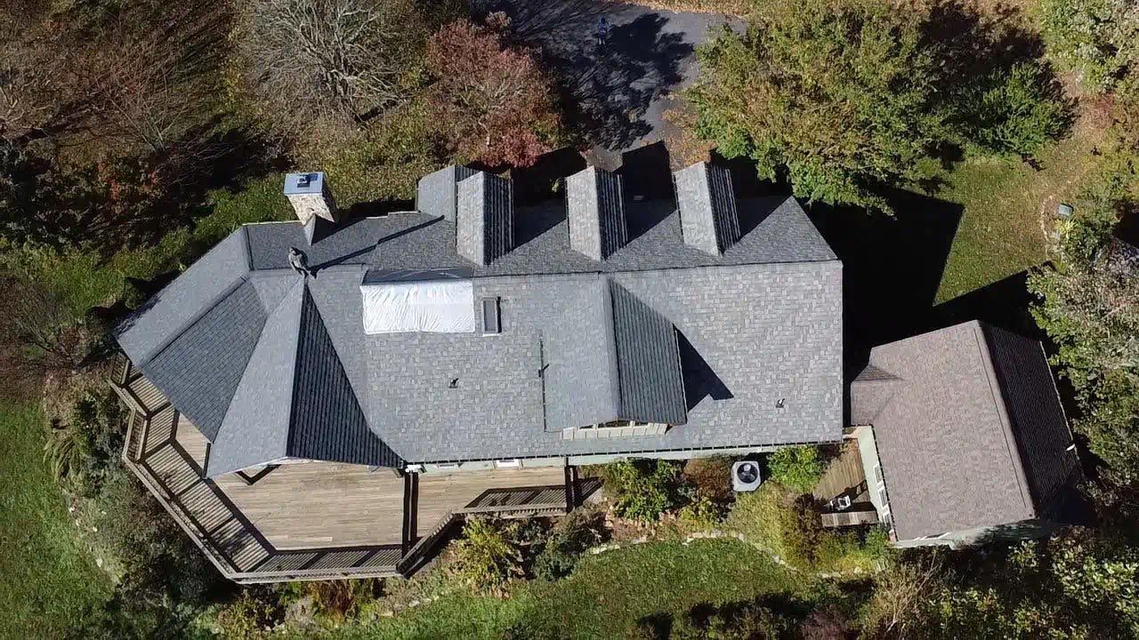 An aerial view of a large house surrounded by trees.