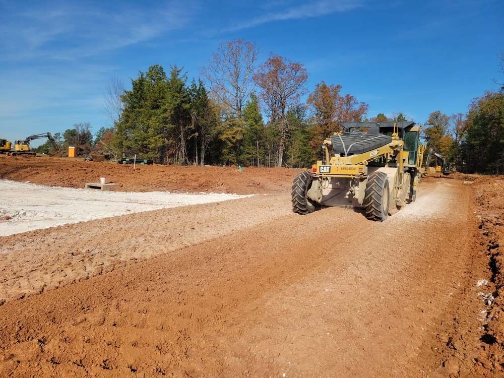 A bulldozer is driving down a dirt road.