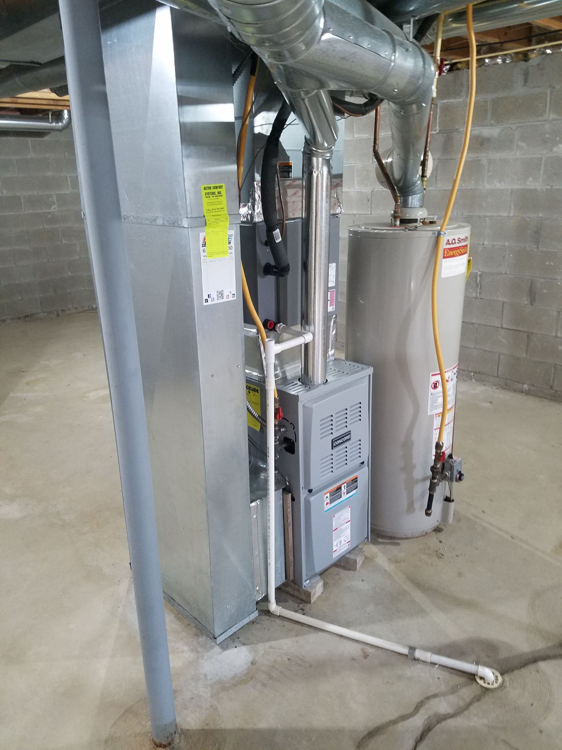 A basement with a water heater and a furnace.