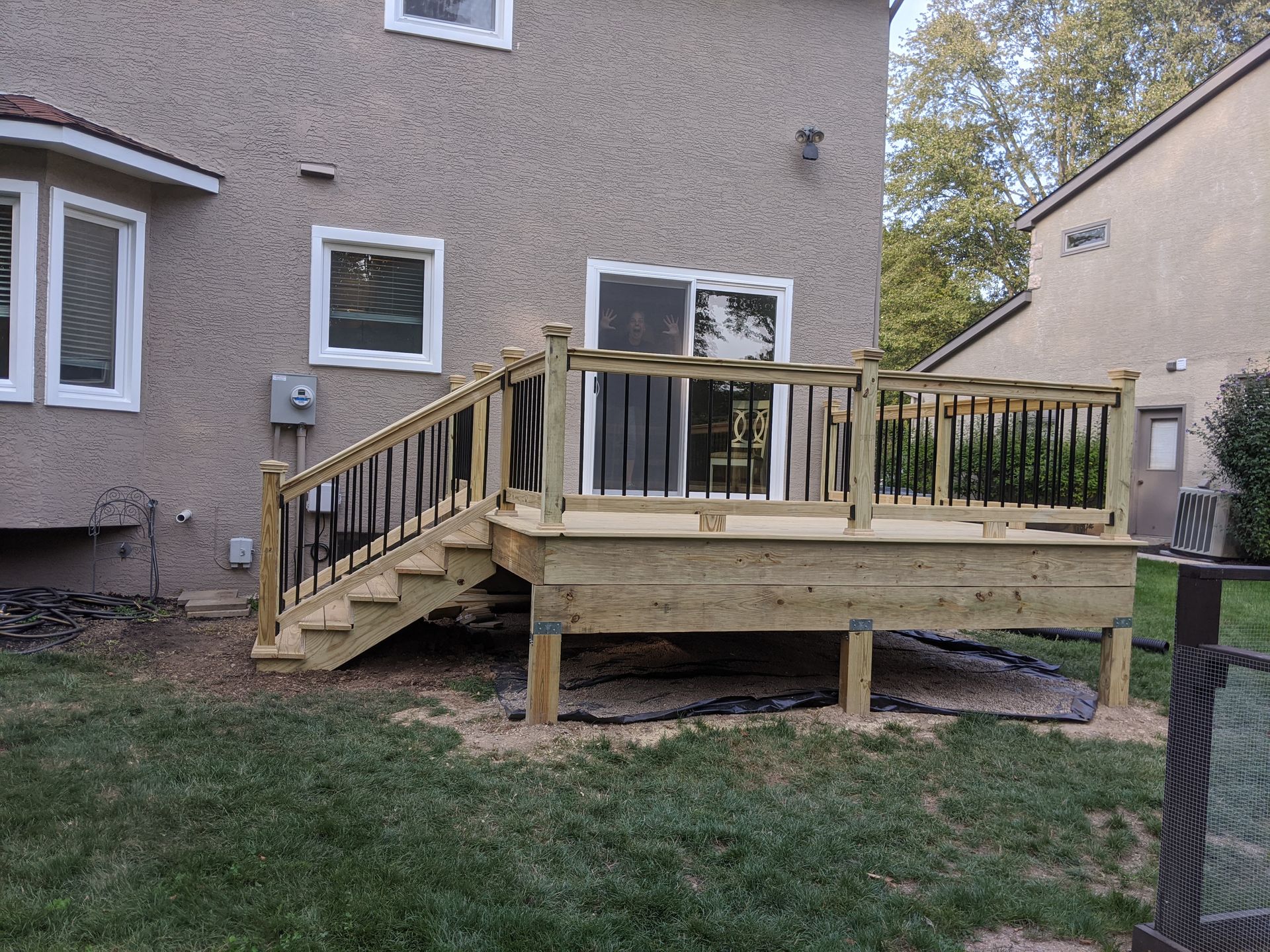 There is a large wooden deck with stairs leading up to it.