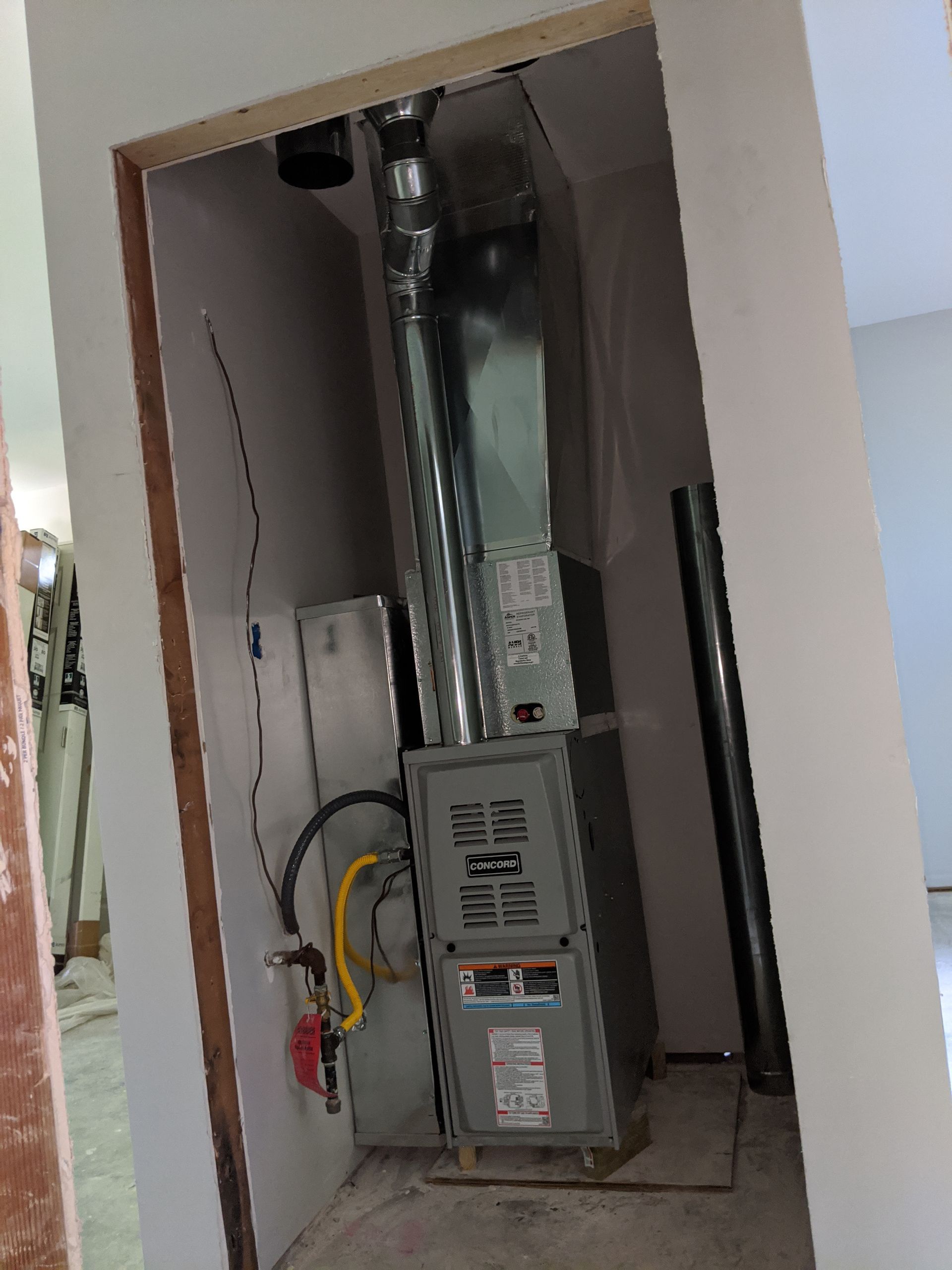 An air conditioner is sitting in a corner of a room.