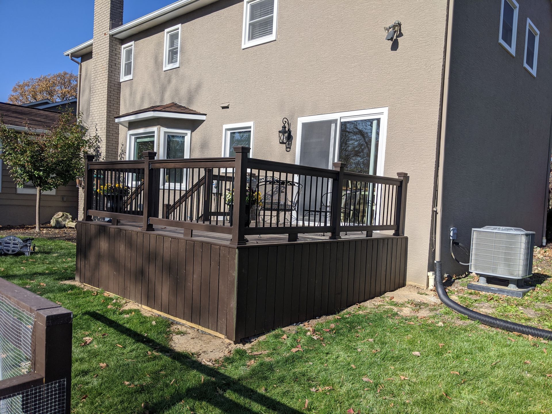 A large house with a large deck in front of it.