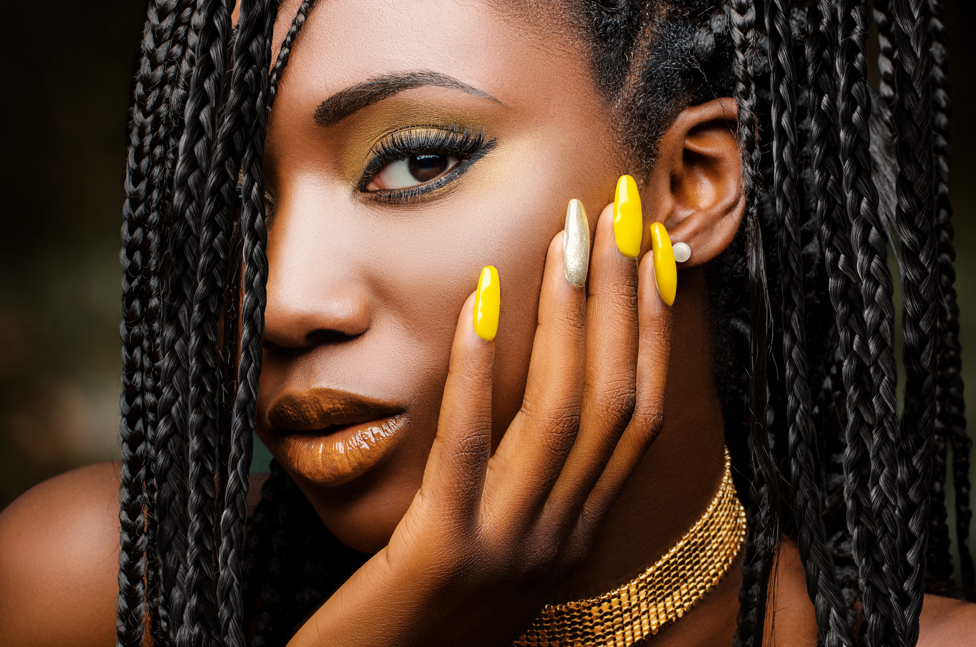 A woman is getting her nails painted at a nail salon.