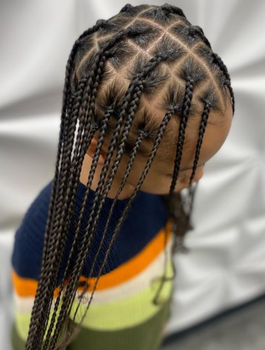 A woman is getting her hair done by a hairdresser in a salon.