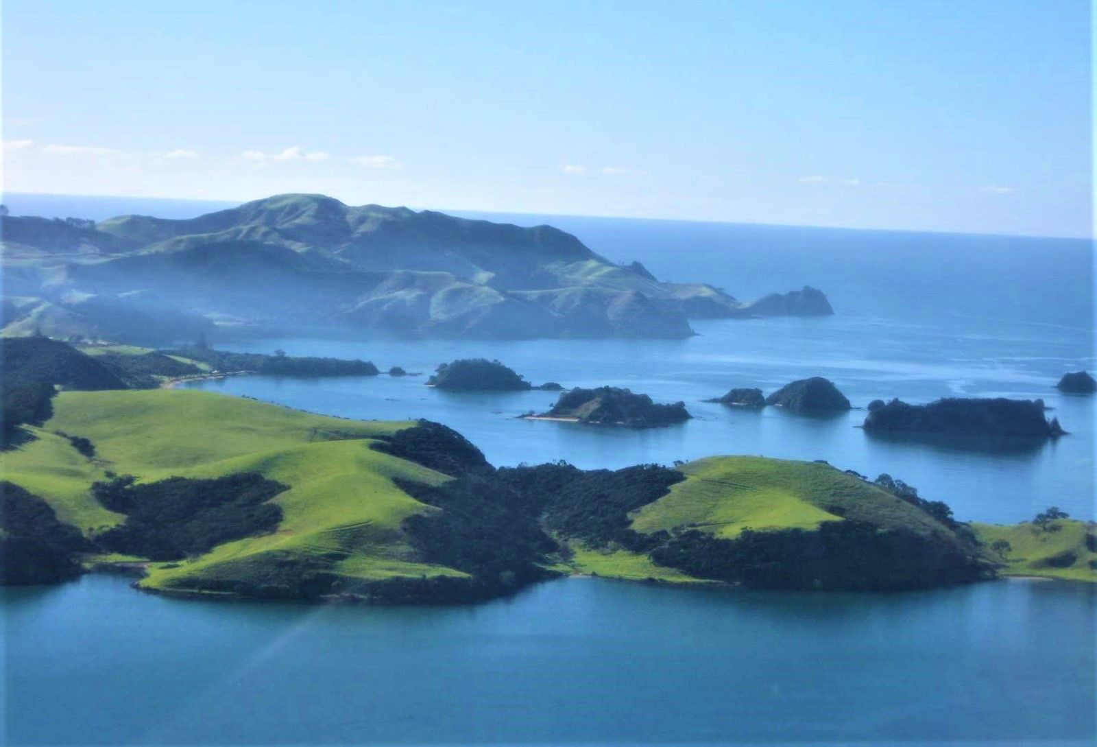 From above Te Akeake Pt with Te Pahi Islands (centre) and Matakā (background)