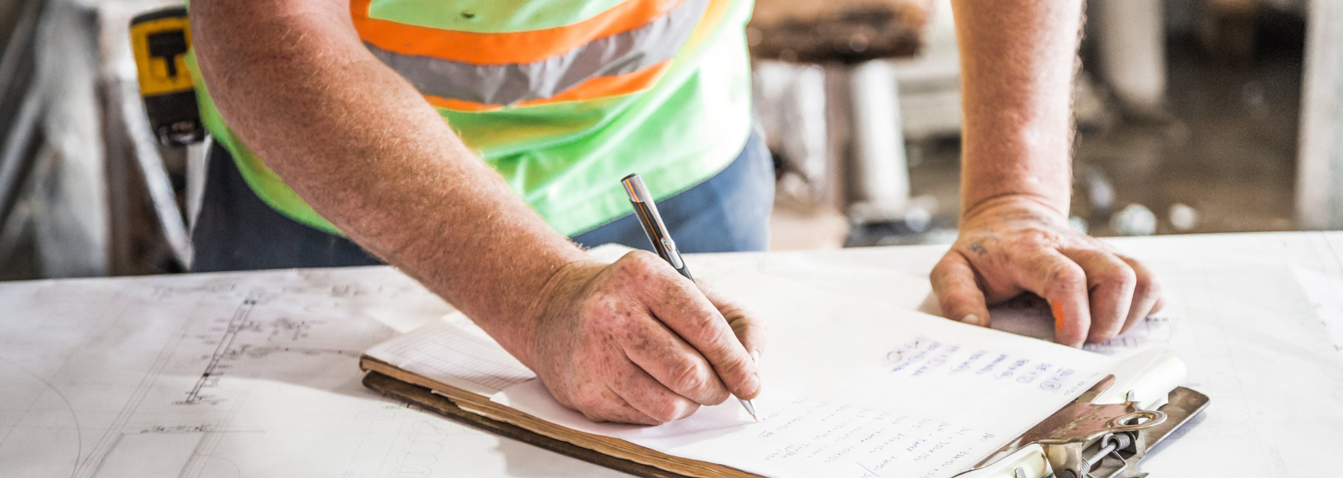 Picture of someone writing on a construction site. 