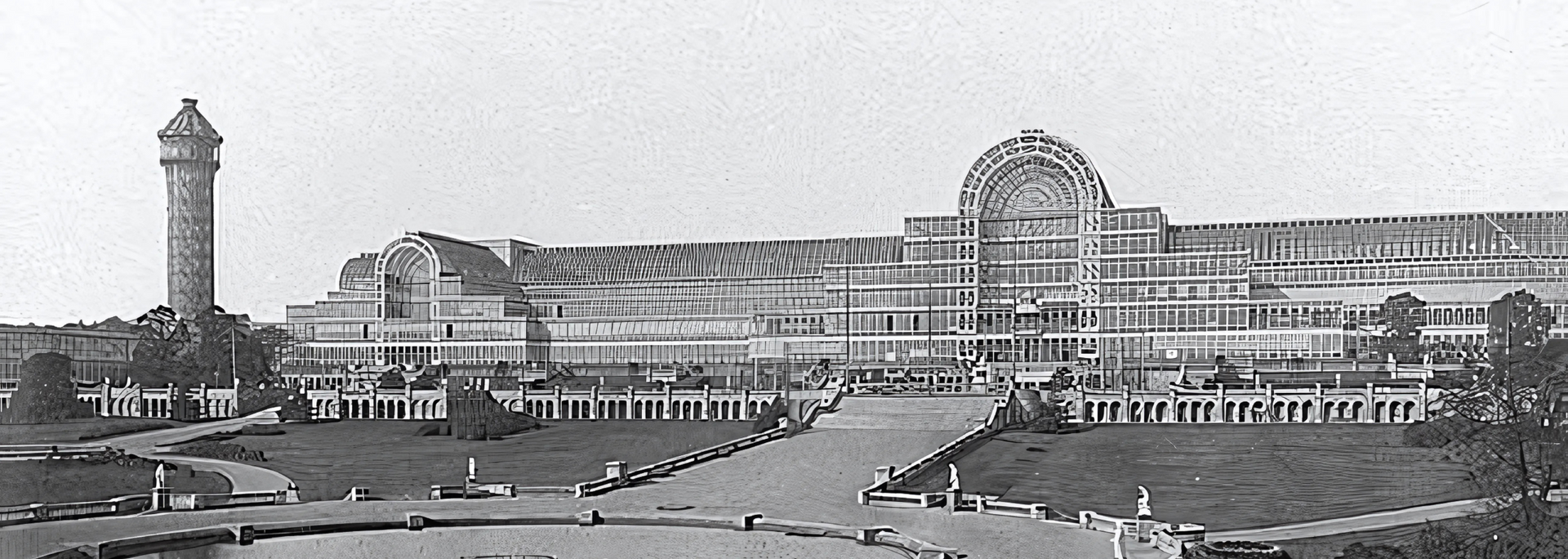 Crystal Palace, London, England, in black and white. Long glass building and tall water tower.