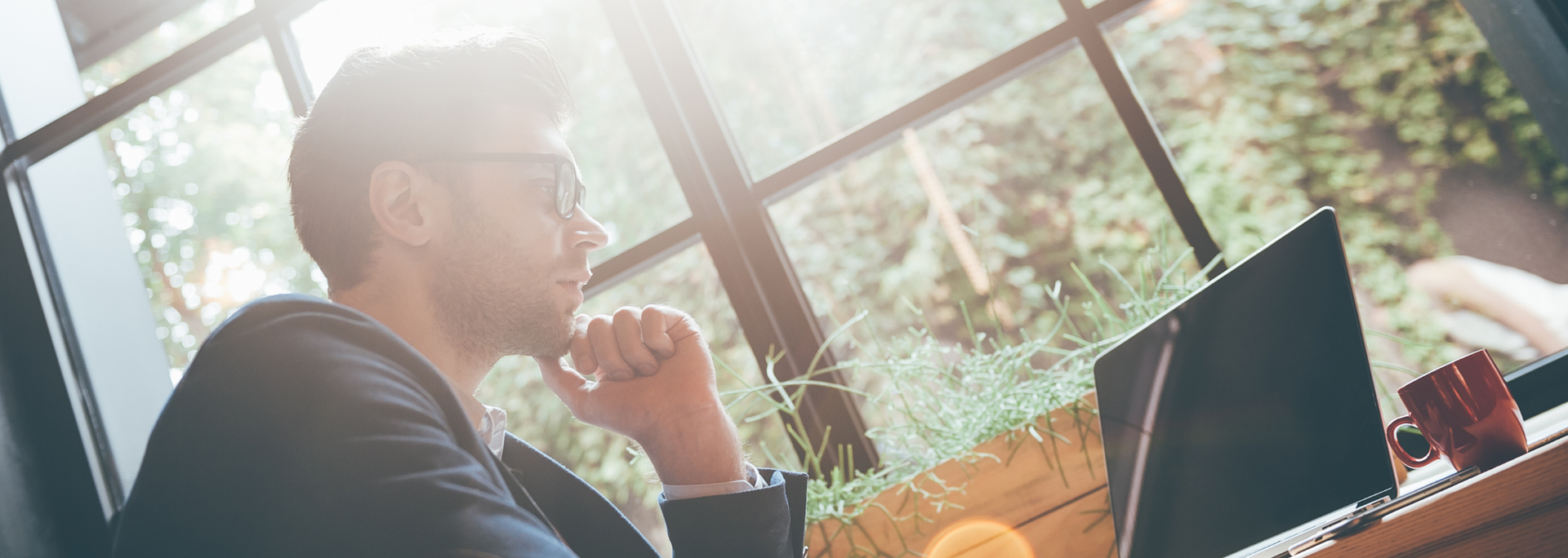 Picture of a person enjoying sunlight through a window. 