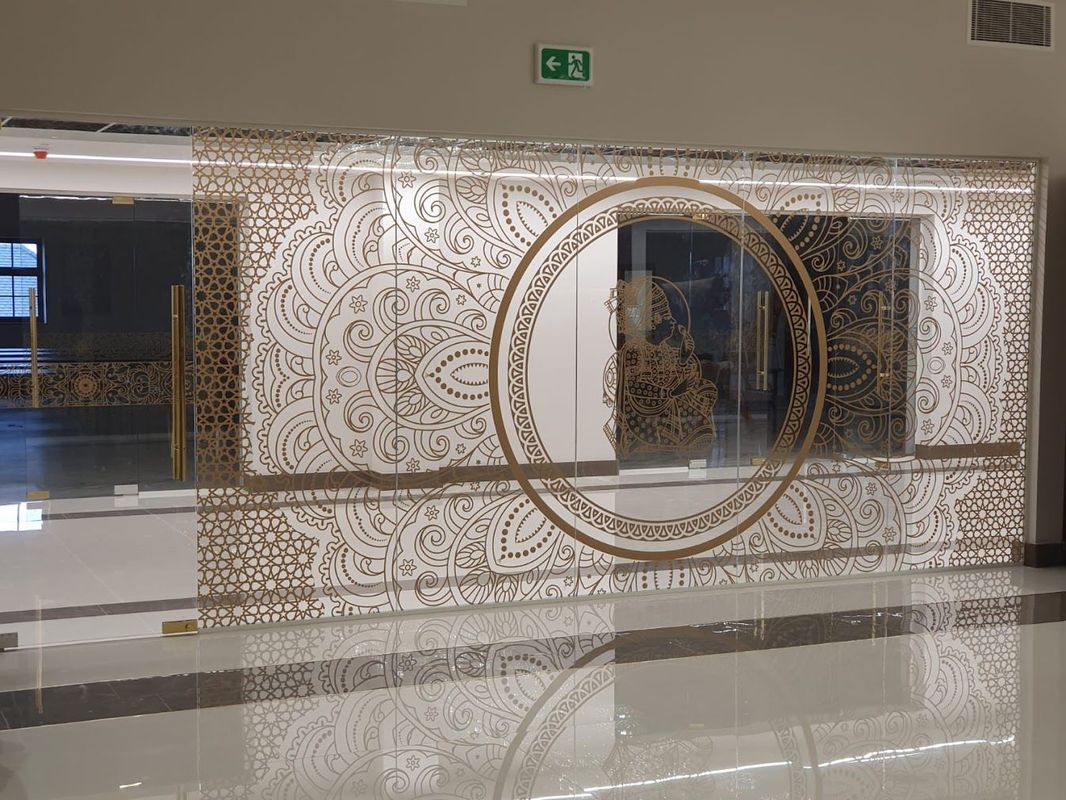 Decorative screen with intricate patterns and a circular mirror.