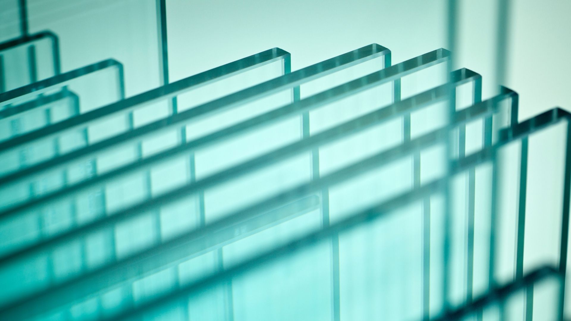 Stacked clear glass sheets, angled view.