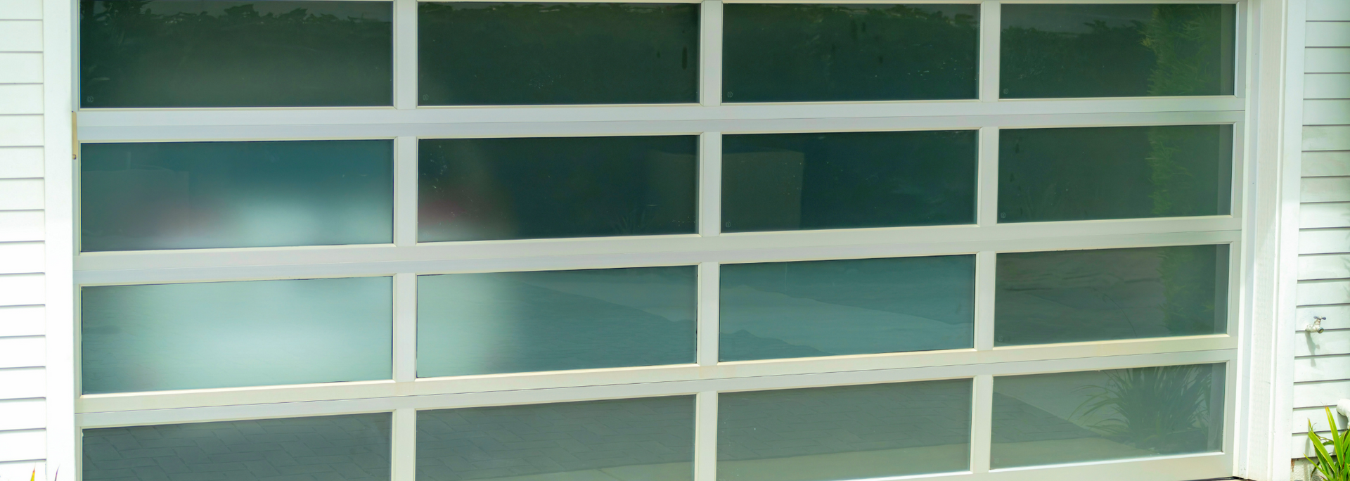 White-framed, multi-pane glass garage door. Reflective.