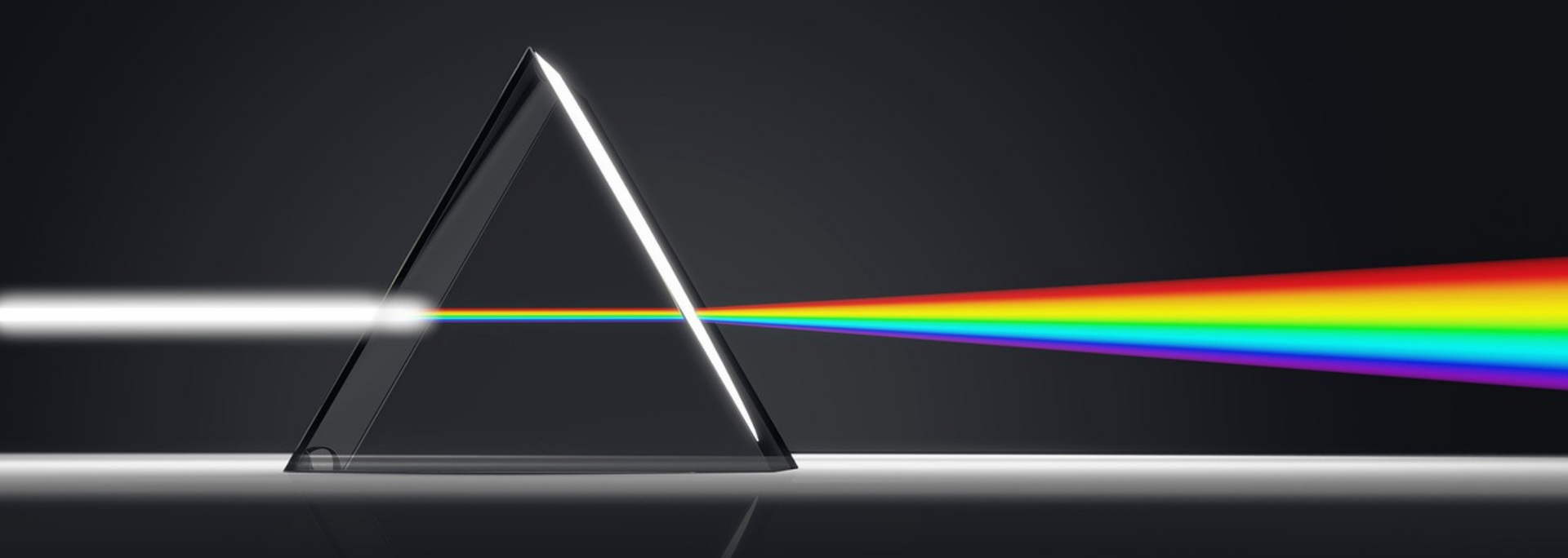 A prism refracting white light into a rainbow spectrum.