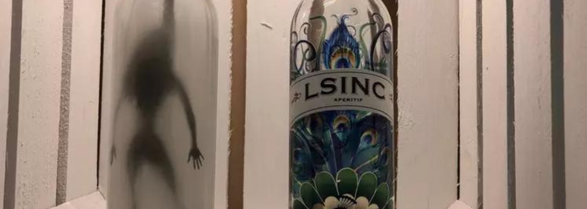 Two decorative bottles: one with a silhouette of a person, the other with a floral design and the word 