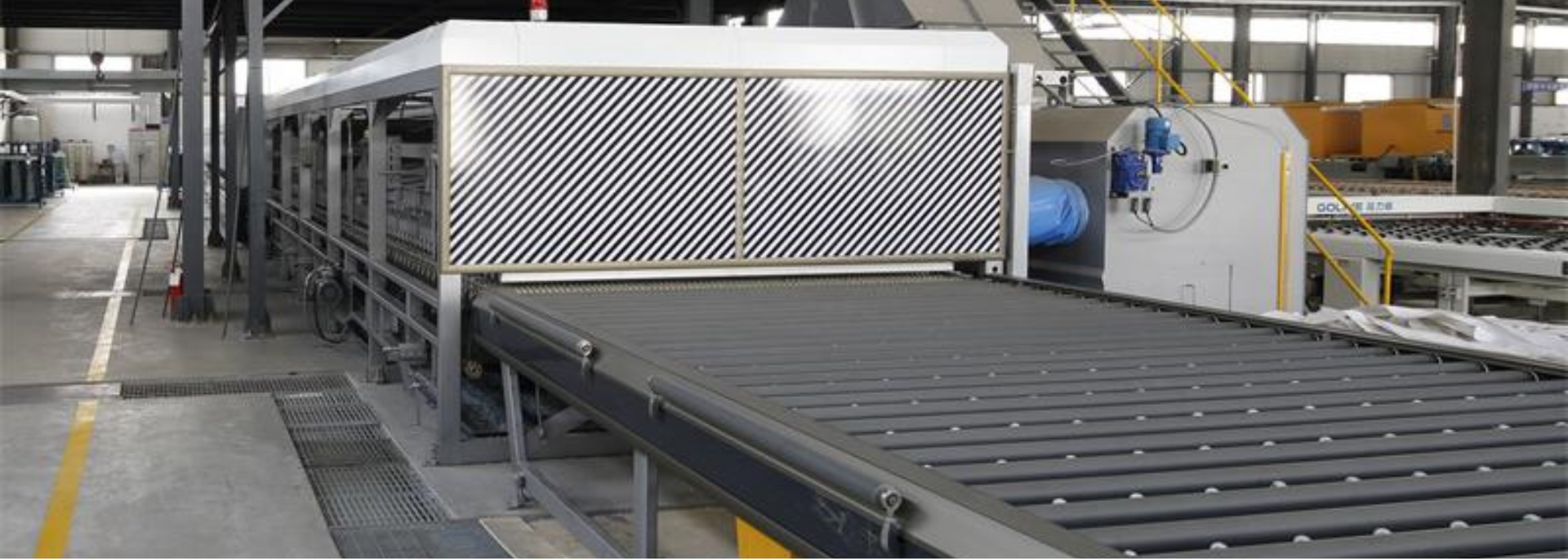 Industrial machine with a conveyor belt in a factory setting.