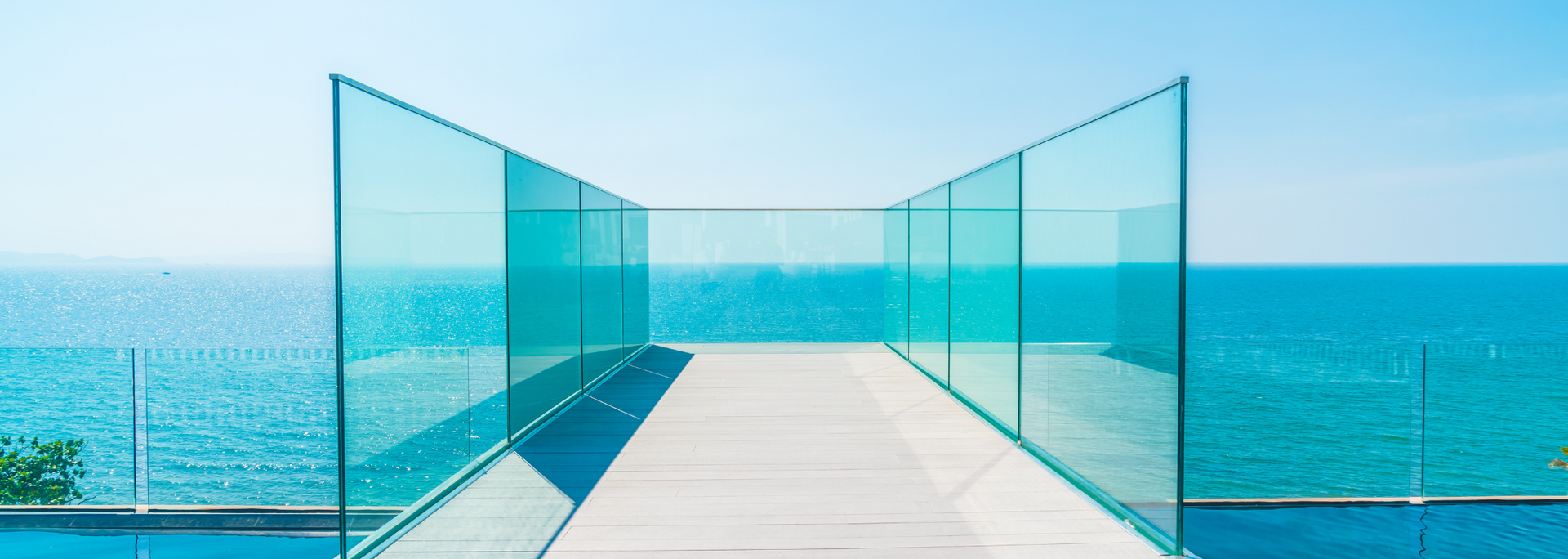 Glass walkway with ocean view. Turquoise sea and sky.