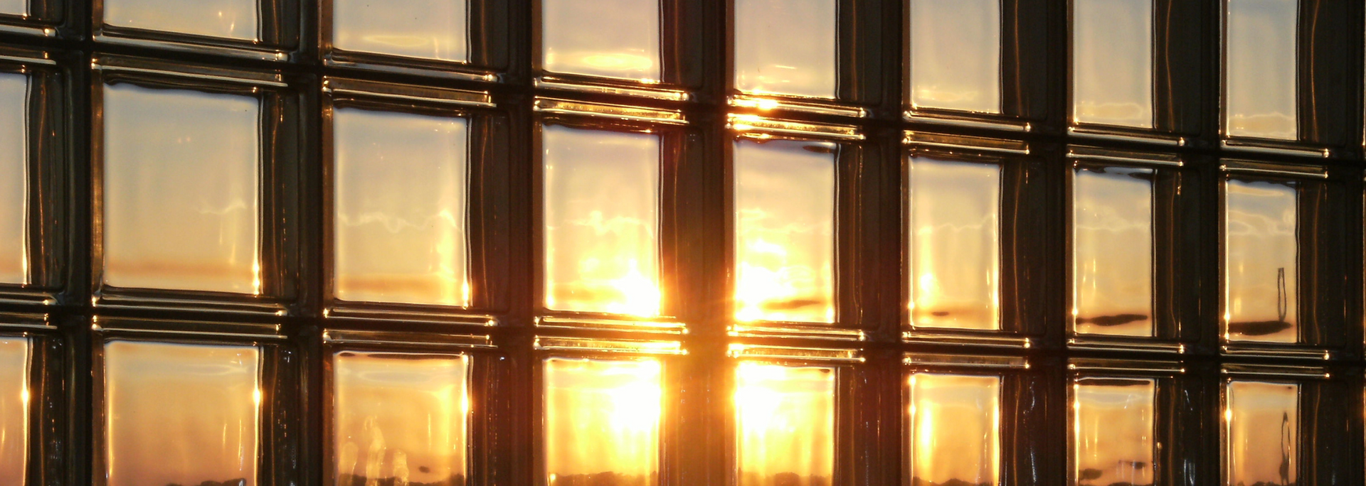 Golden sunset viewed through a grid of windows.