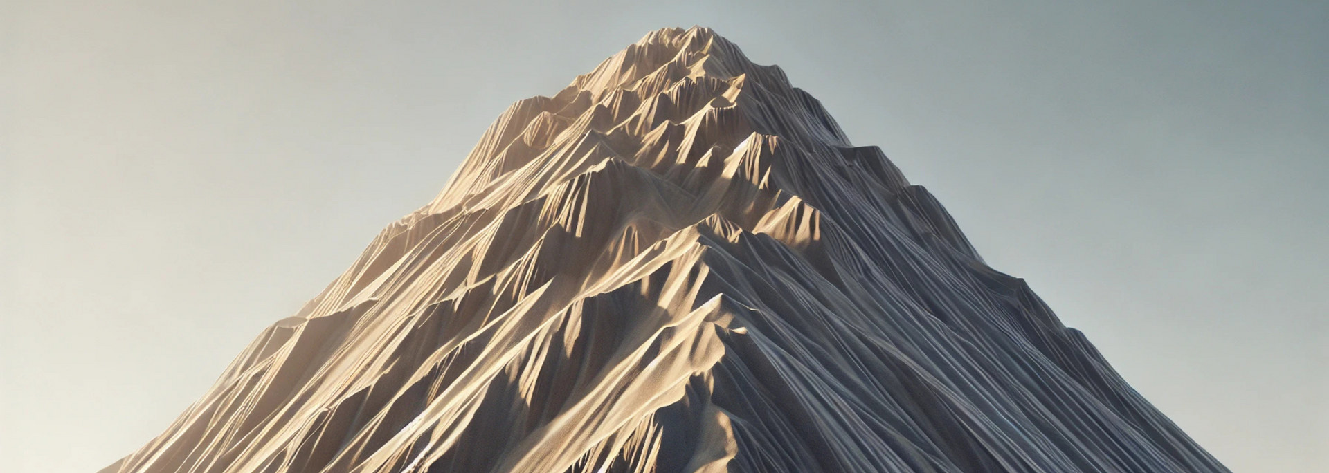 A towering, craggy mountain peak against a pale blue sky.