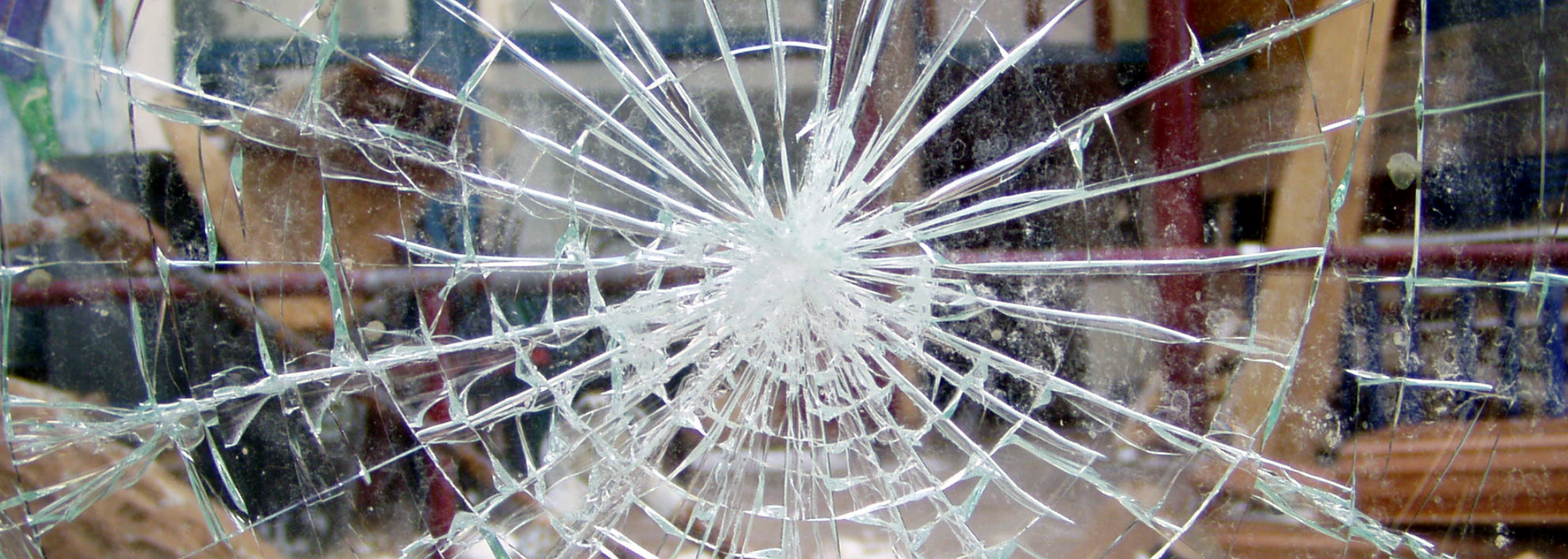 A shattered window with cracks radiating from a central point.