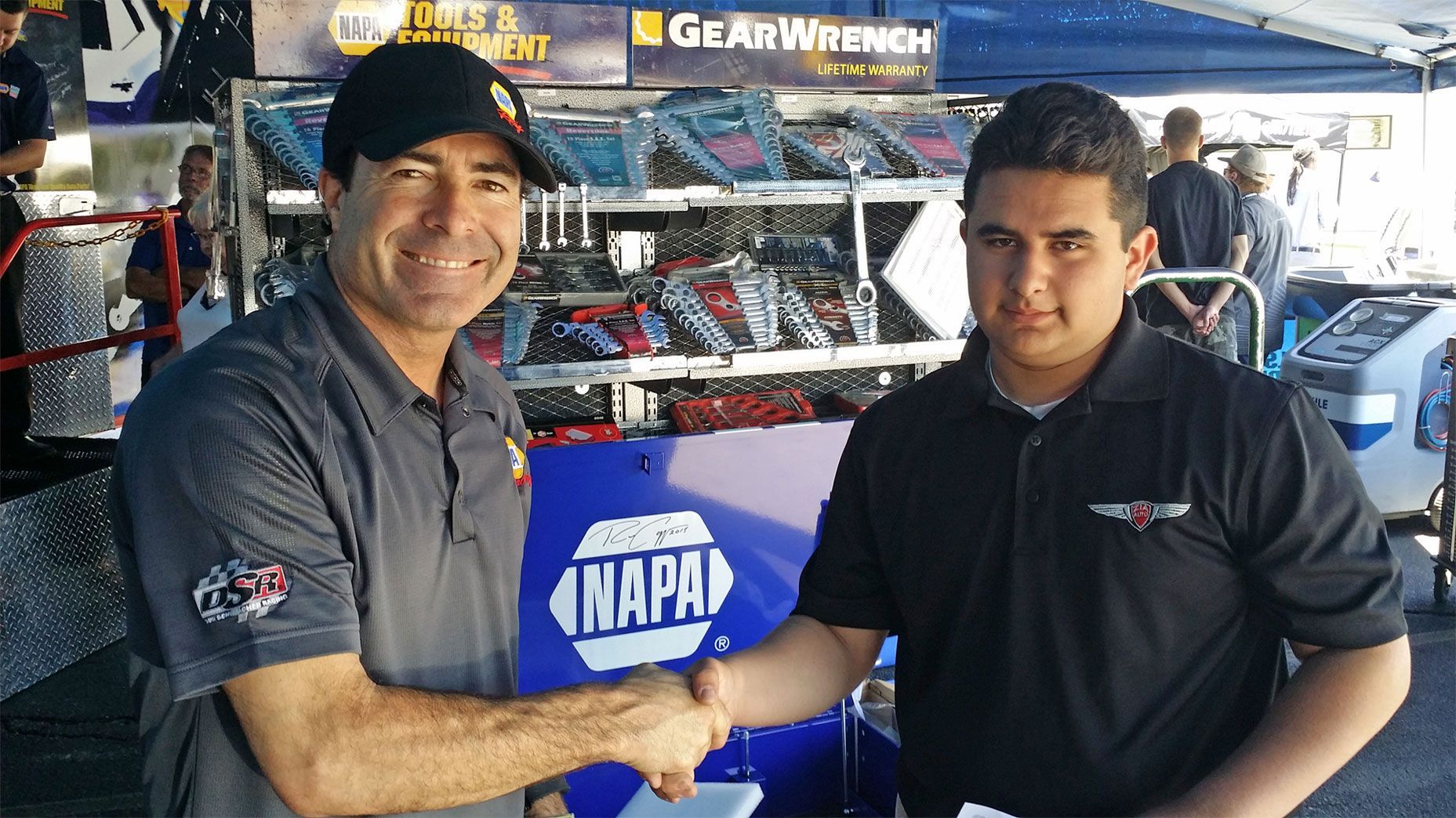Two men shaking hands in front of a napa sign | Zia Automotive