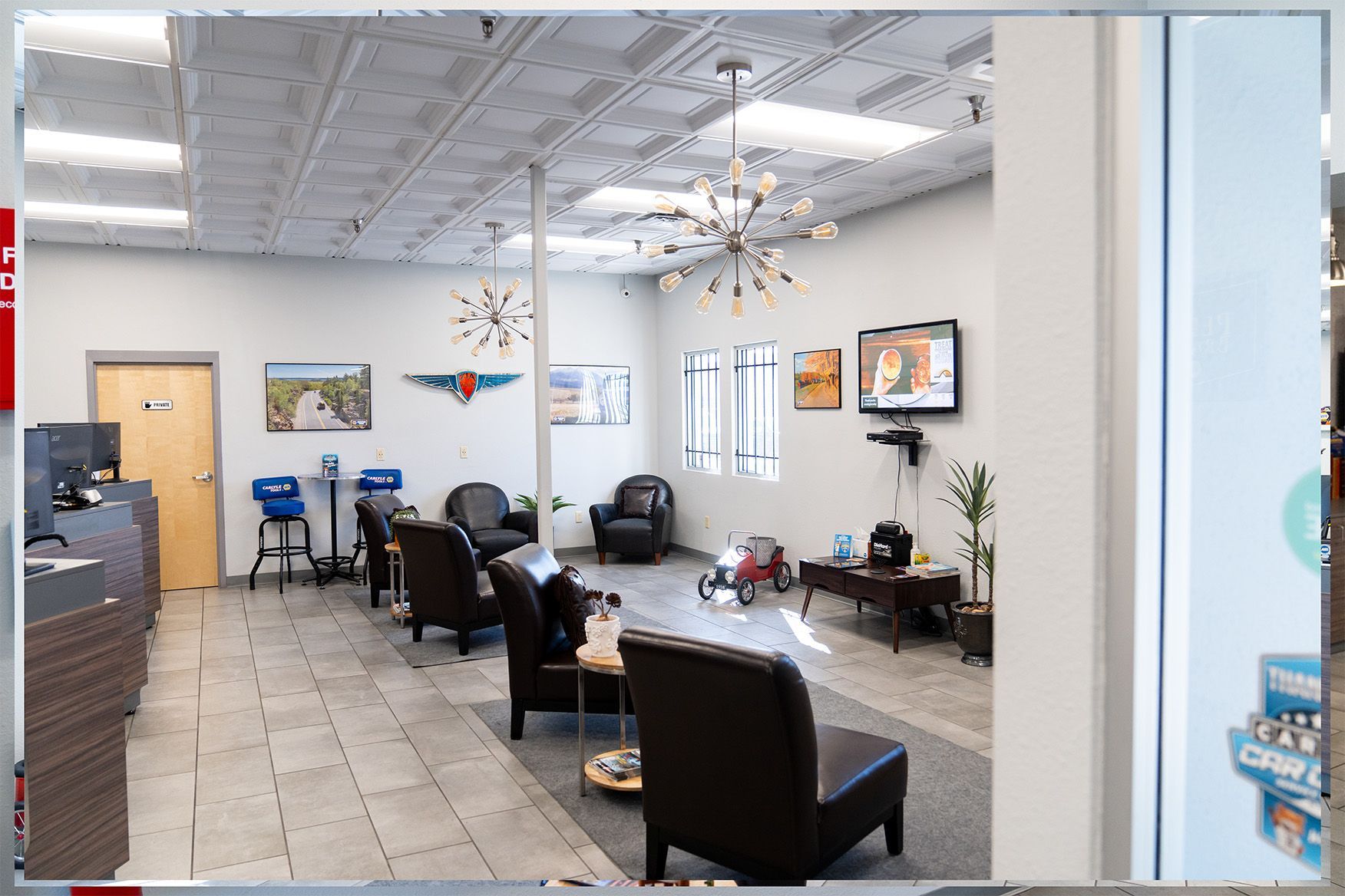 A room with a lot of chairs and a television on the wall | Zia Automotive