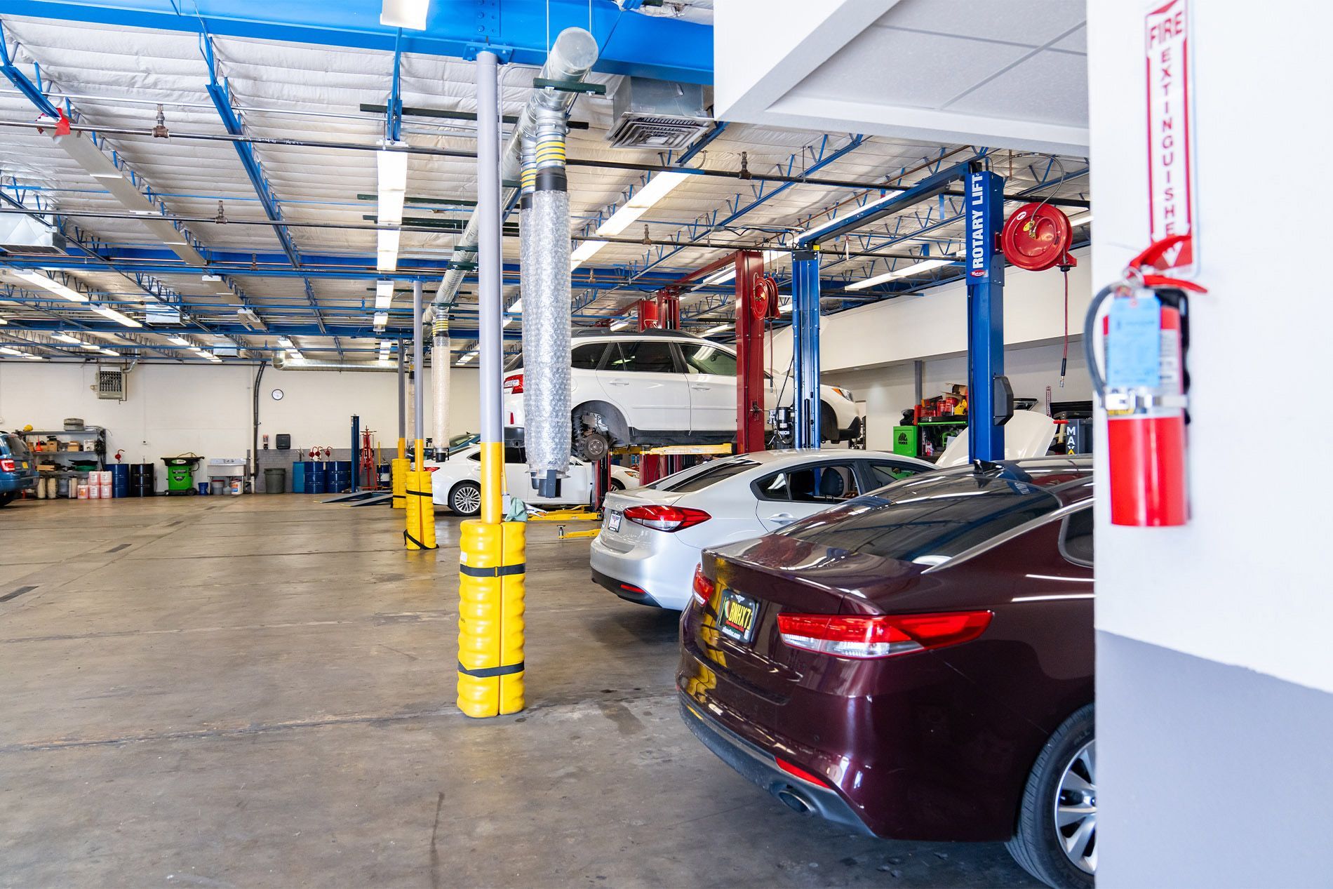 A row of cars are parked in a garage. | Zia Automotive