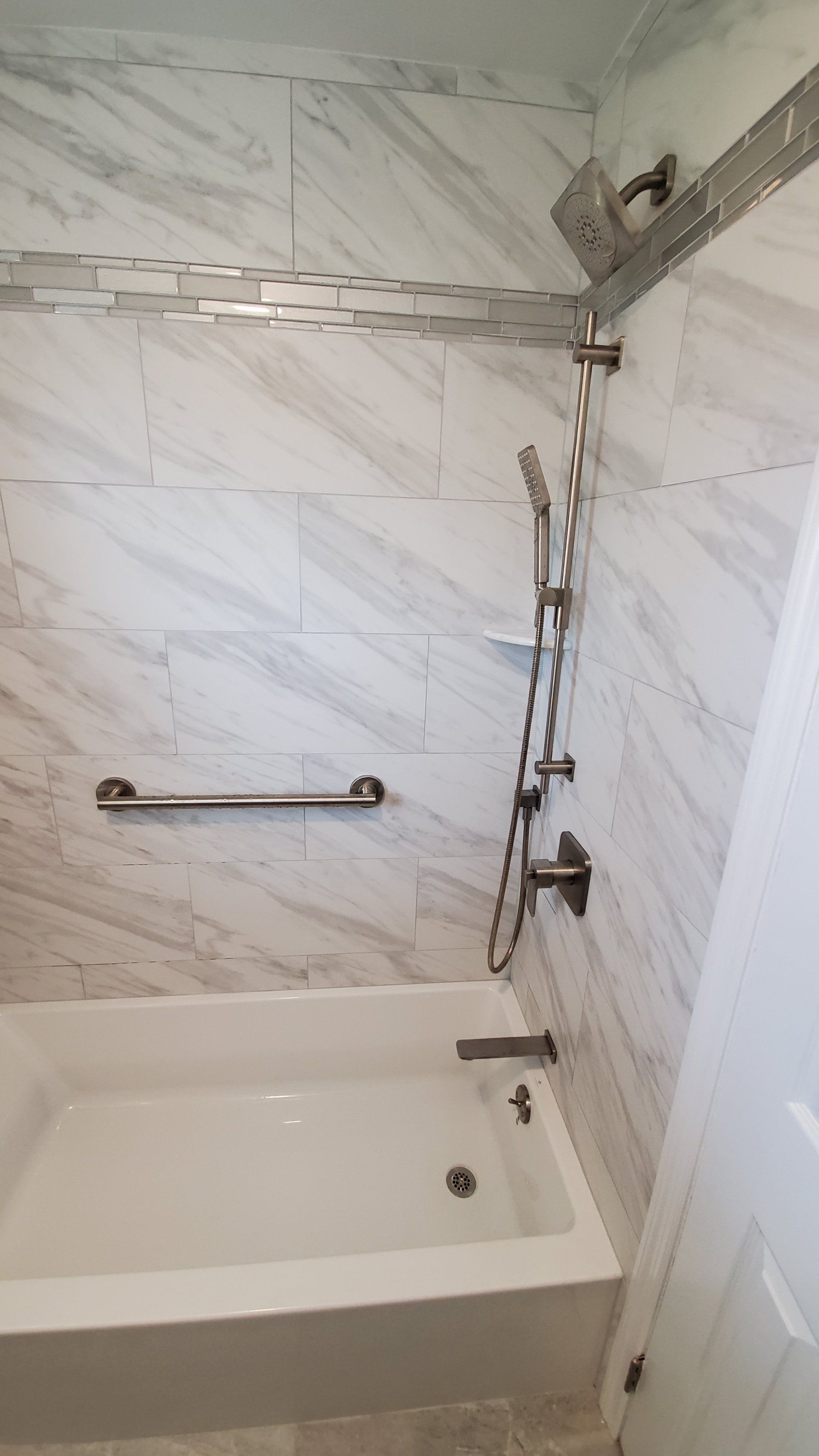 A bathroom with a bathtub and a shower.