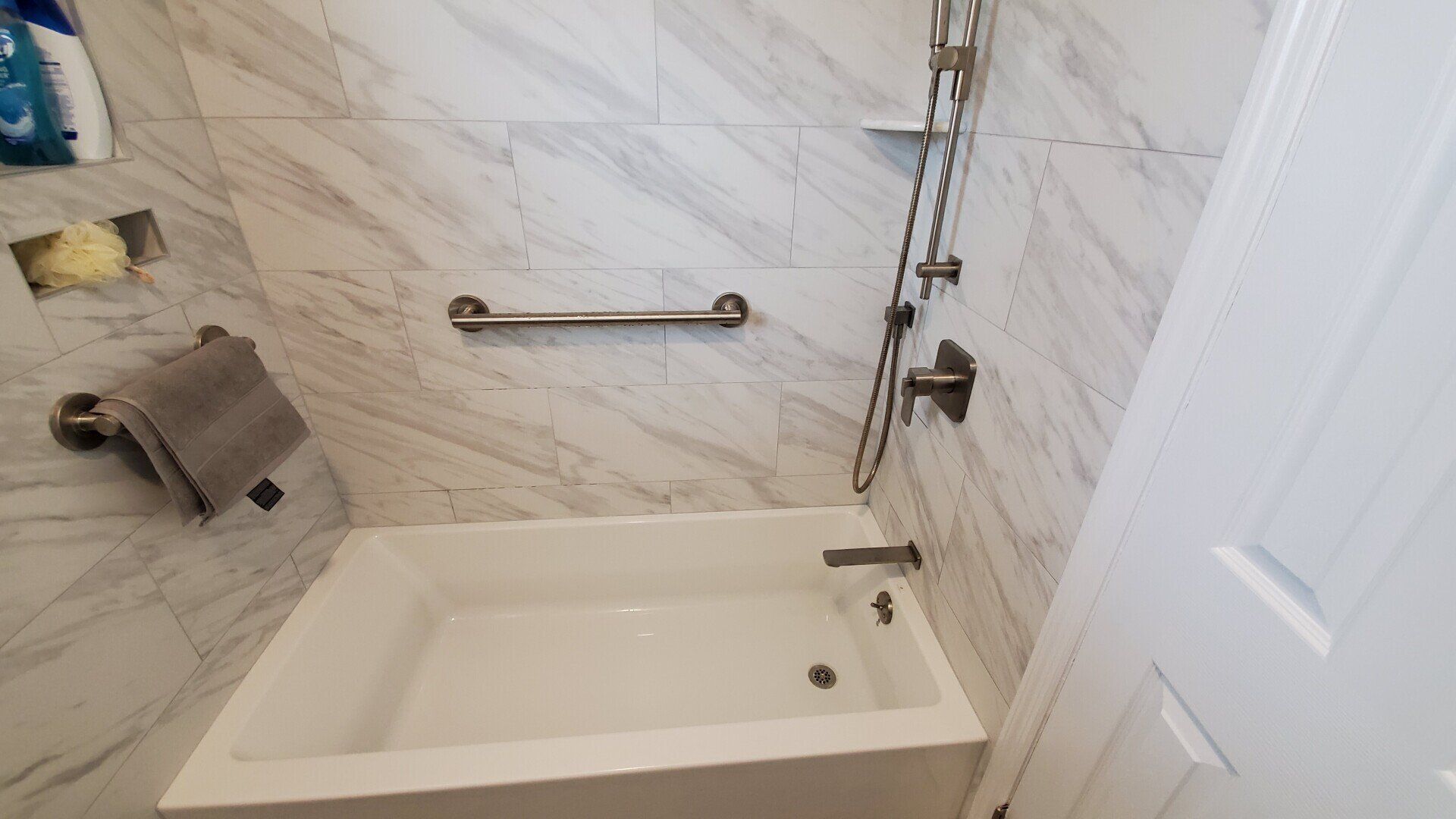 A bathroom with a bathtub and a shower.