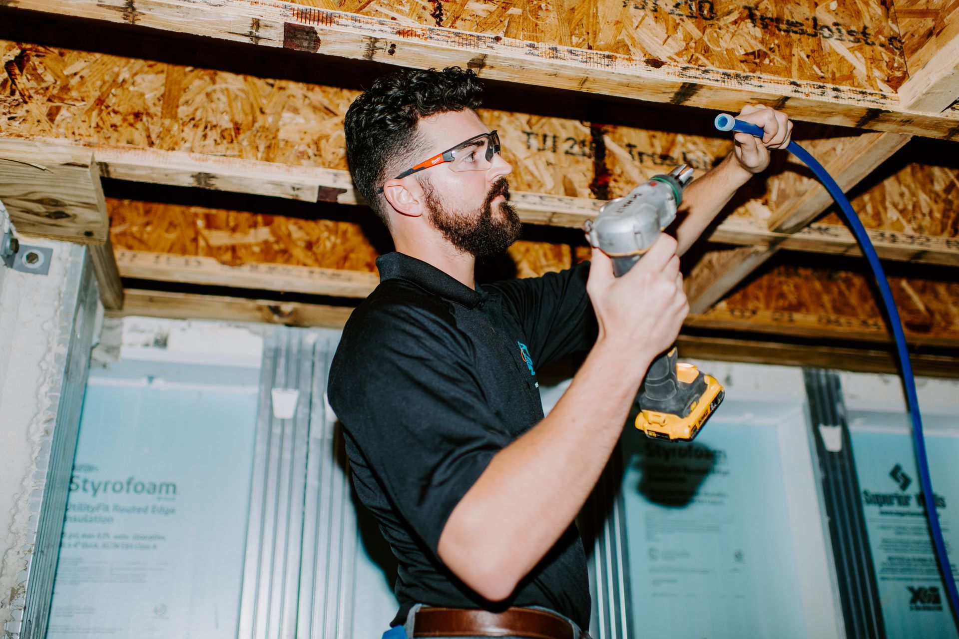 Two men are carrying a large box in a warehouse.