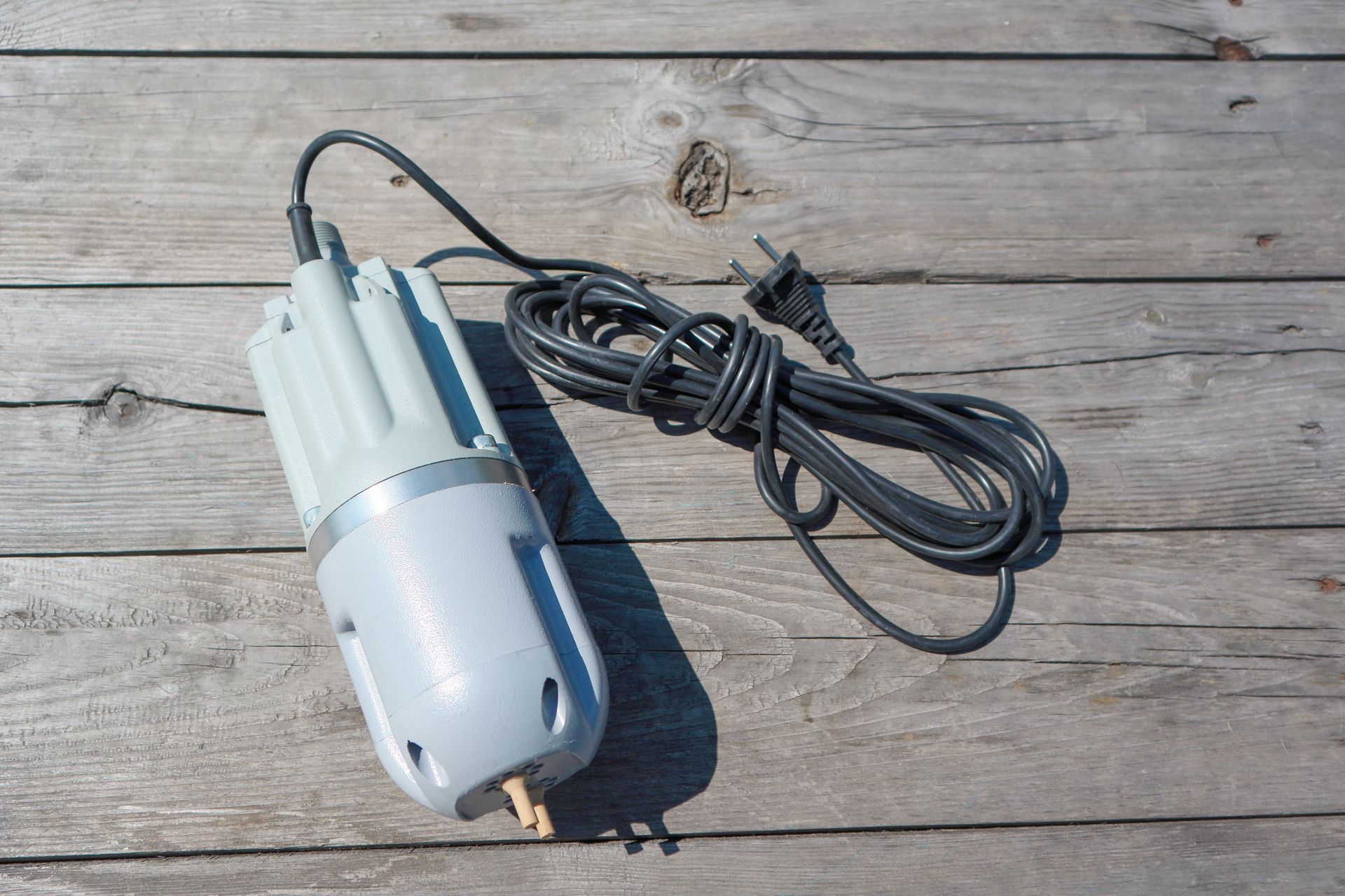 A small electric device is sitting on a wooden table.