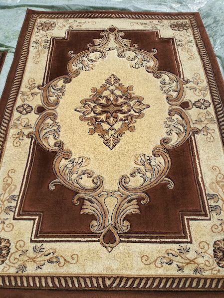 A brown and tan rug with a floral design on it