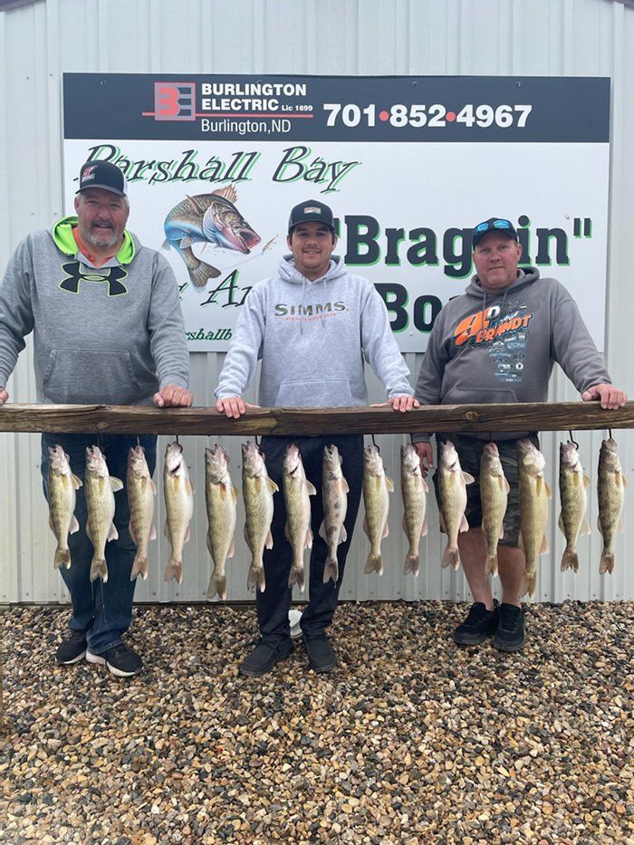 fishermen posing with their catches