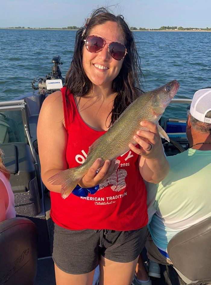 girl in red shirt holding fish