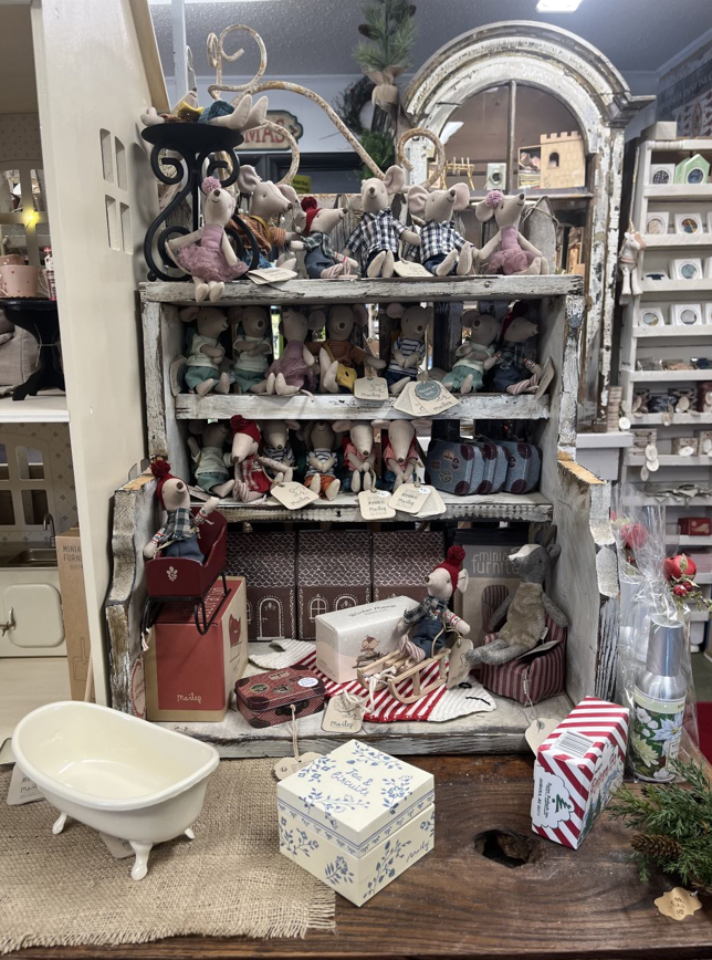 A shelf filled with toys and a bathtub on a table.