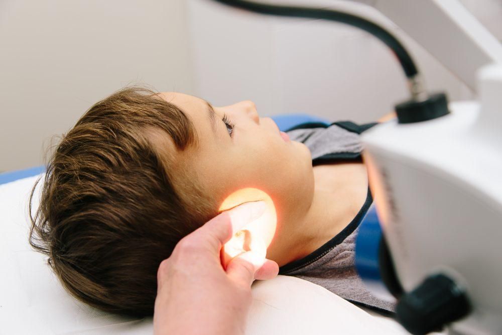 Safe ear wax removal with microsuction in Ealing Audiologist performing safe microsuction ear wax removal in Ealing clinic.