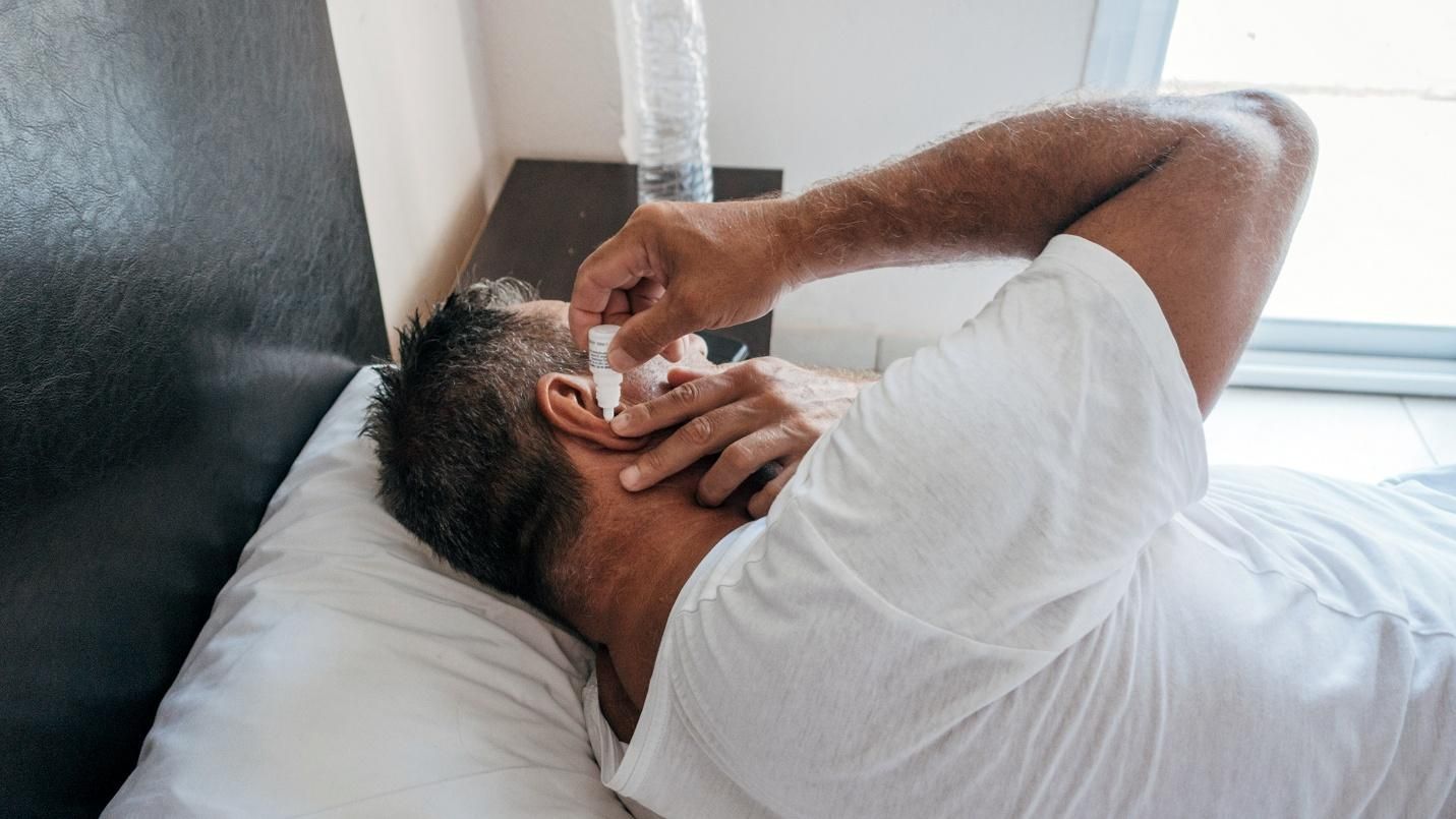 Adult experiencing muffled hearing due to ear wax blockage