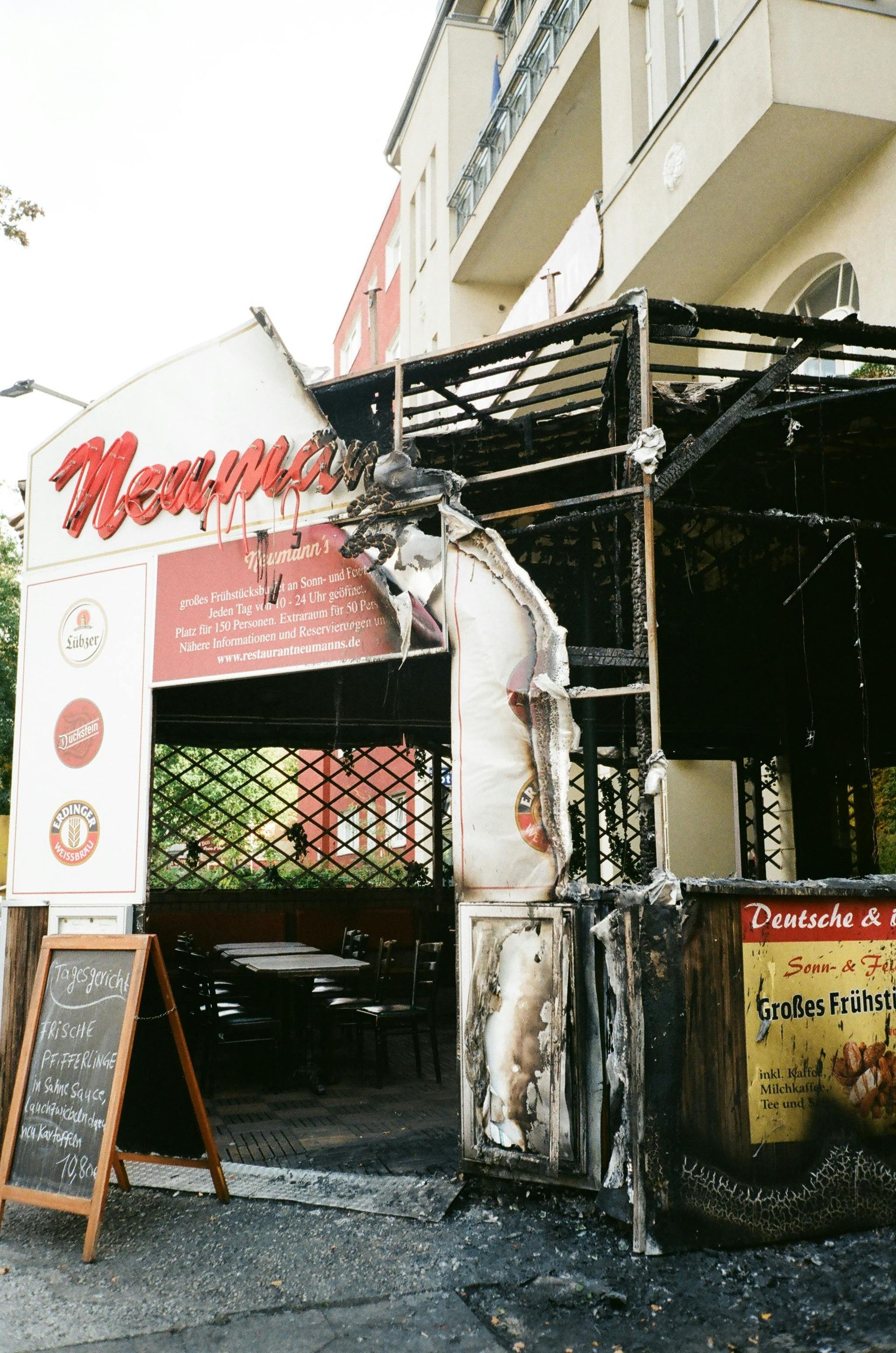 Charred remains of a restaurant's exterior, sign reading