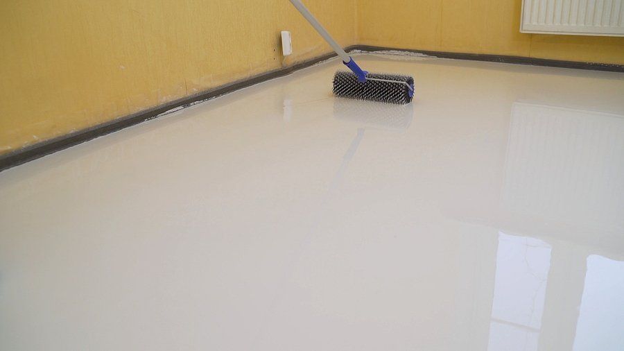worker installing epoxy in the floor