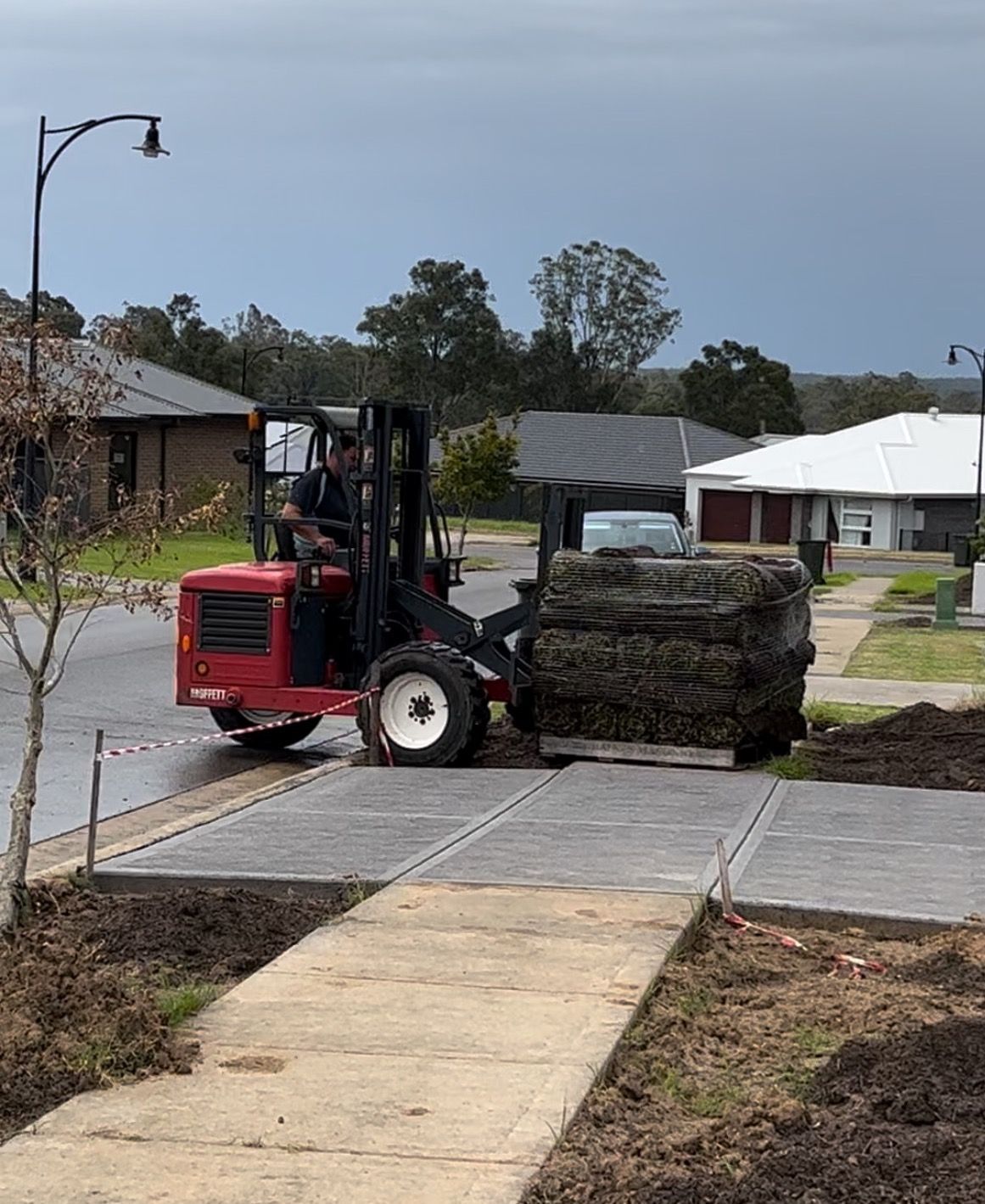 Man Laying Sod For New Garden Lawn — Aussie Turf Supplies In Minmi NSW