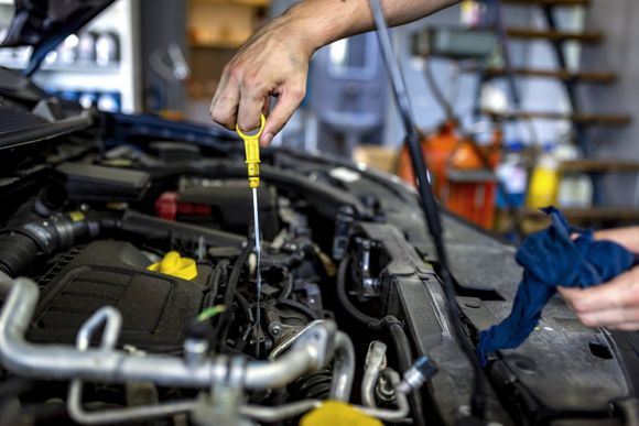Man Checking Engine Fuel — Waxahachie, TX — Walton’s Total Car Care