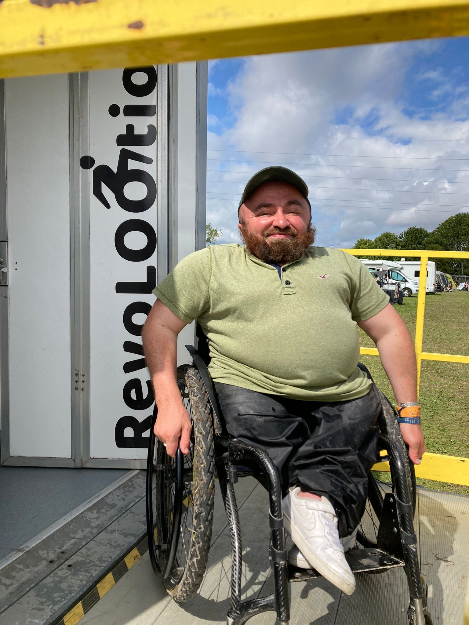 a man in a wheelchair is standing in front of a sign that says revolootio