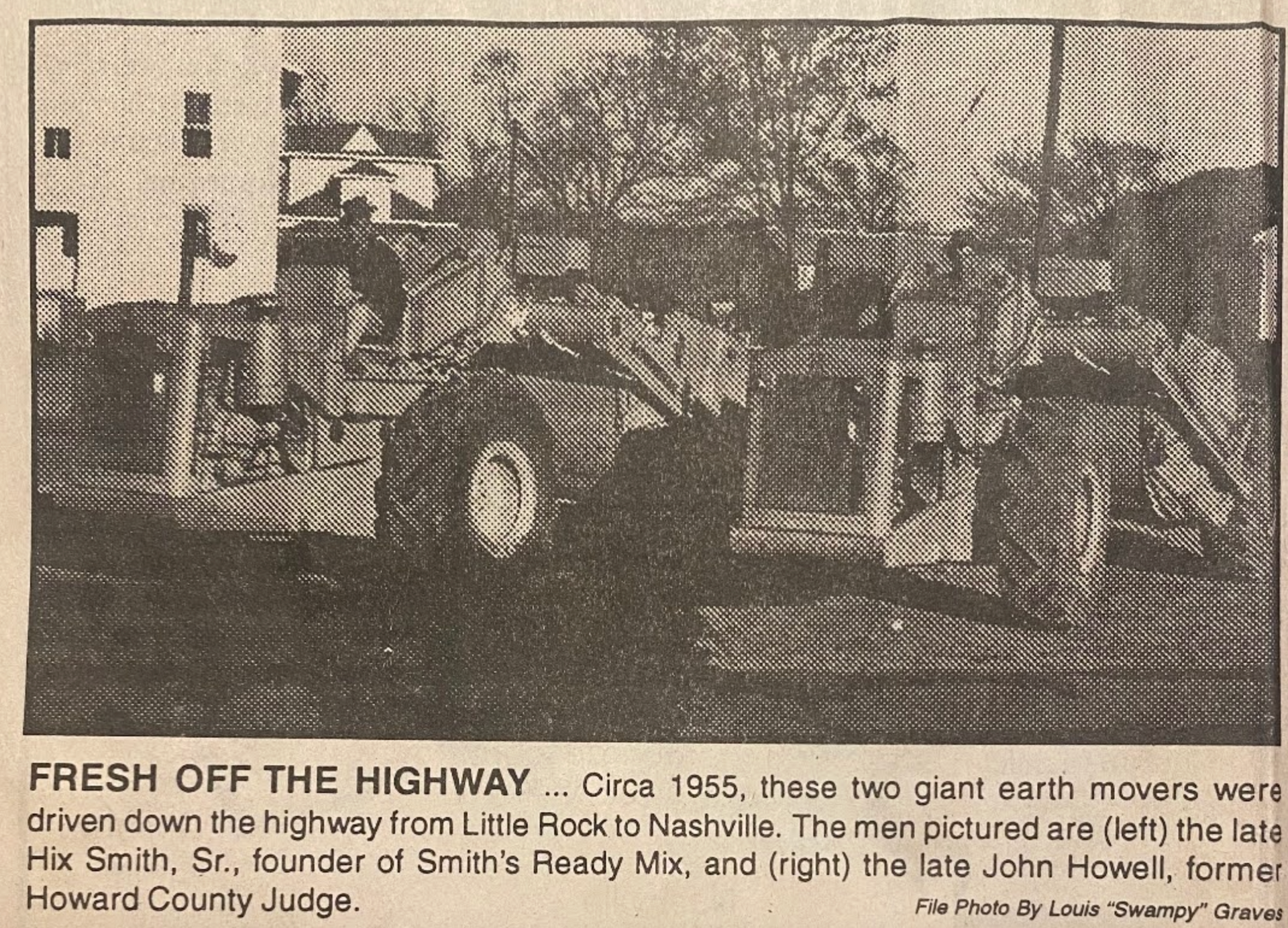 Two earth movers on a road, circa 1955, with text identifying Hix Smith, Sr. and John Howell.