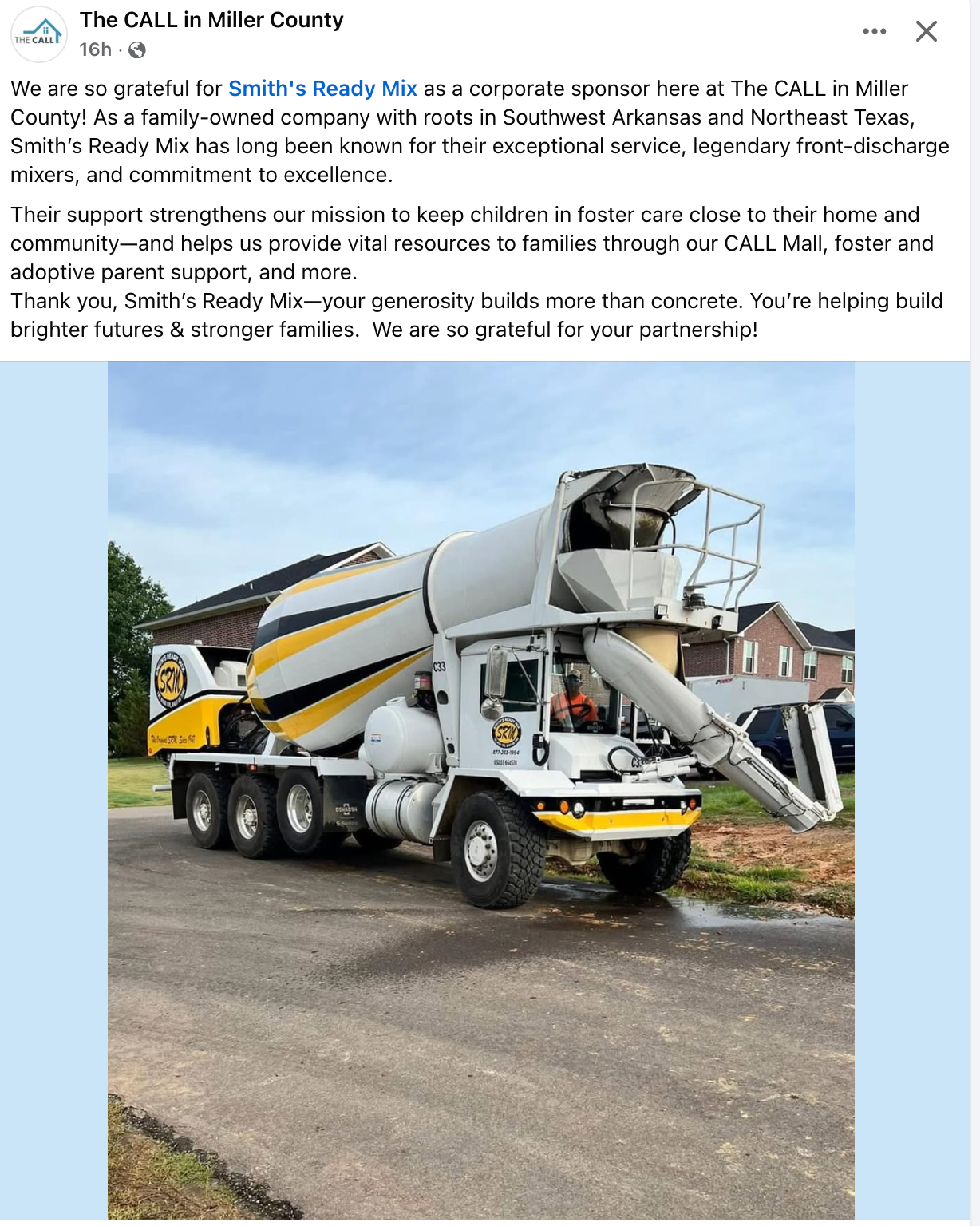 Cement truck with yellow and black stripes in front of a house, supporting The CALL in Faulkner County.