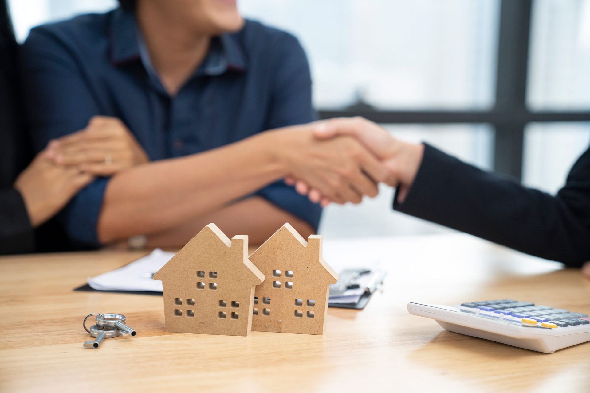 A mortgage broker reviewing home loan options with first-time homebuyers. A mortgage broker reviewing home loan options with first-time homebuyers.