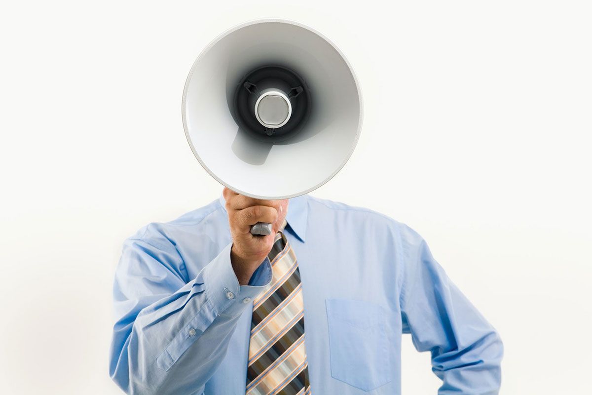 executive male yelling into a megaphone